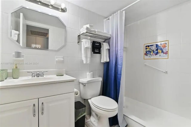 bathroom with decorative backsplash, tile walls, toilet, vanity, and a shower with curtain