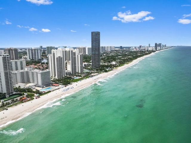 bird's eye view with a water view and a beach view