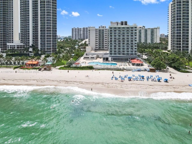 drone / aerial view with a water view and a beach view