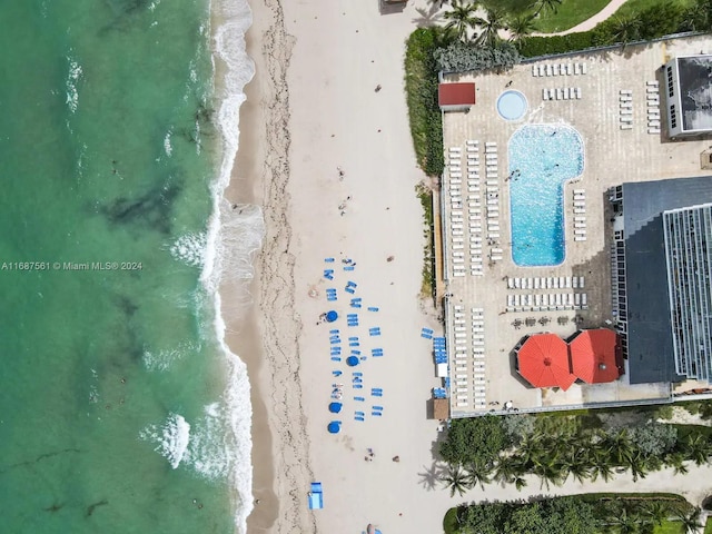 drone / aerial view with a water view and a beach view