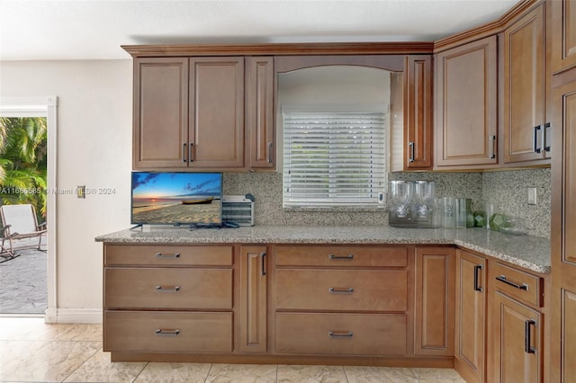 kitchen with backsplash and light stone countertops