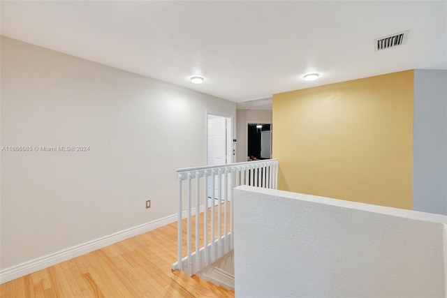 corridor featuring hardwood / wood-style floors