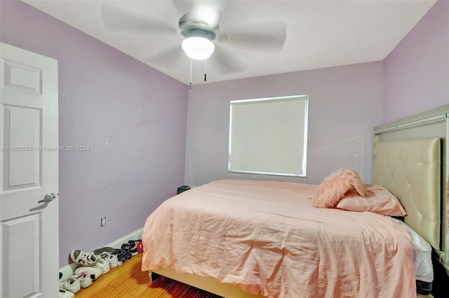 bedroom featuring hardwood / wood-style floors and ceiling fan