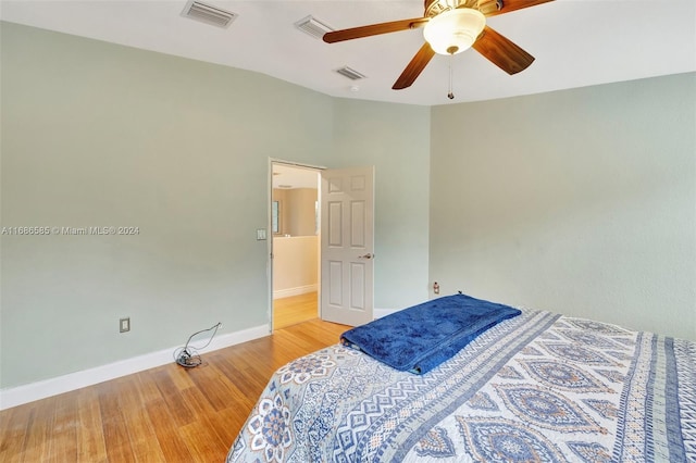 bedroom with ceiling fan, light hardwood / wood-style flooring, and lofted ceiling