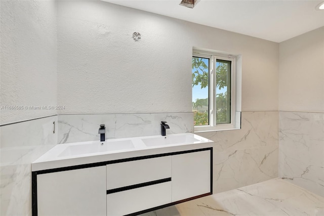 bathroom with vanity and tile walls