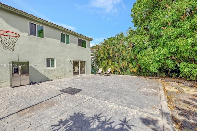 back of property with a patio