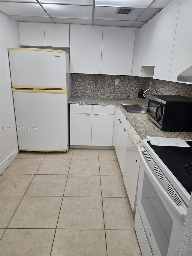 kitchen with backsplash, white cabinetry, a drop ceiling, sink, and white appliances