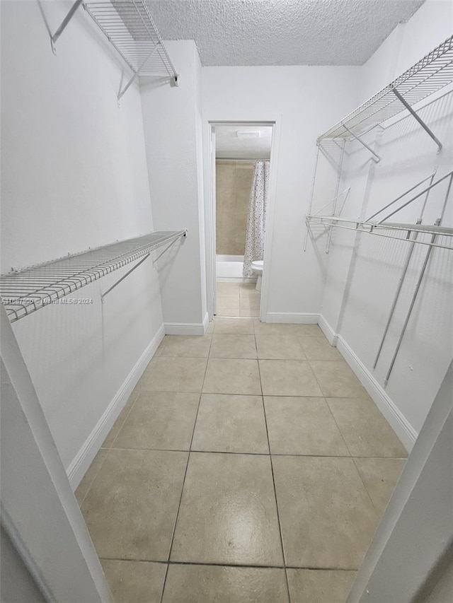 walk in closet featuring light tile patterned floors