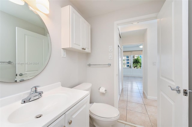 bathroom with vanity, toilet, and tile patterned floors