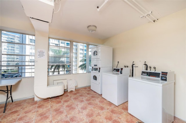 clothes washing area with separate washer and dryer and stacked washing maching and dryer