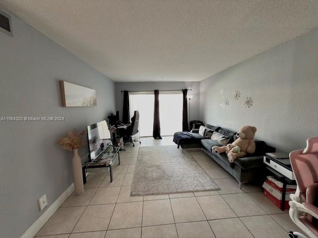 living room with light tile patterned floors and a textured ceiling