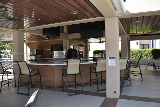 view of patio featuring an outdoor bar