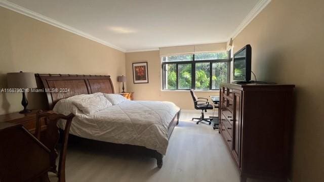 bedroom featuring crown molding and light wood-type flooring