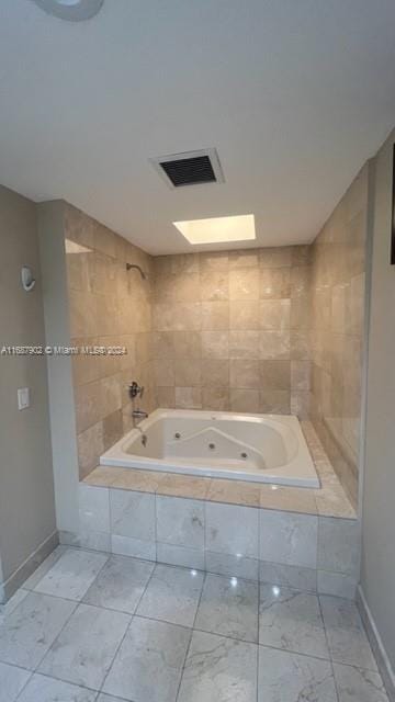 bathroom with a relaxing tiled tub