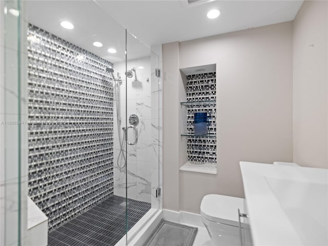 bathroom with recessed lighting, toilet, baseboards, and a marble finish shower