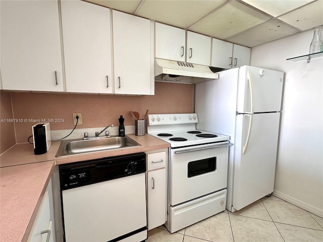 kitchen with white cabinetry, light tile patterned floors, a paneled ceiling, and white appliances