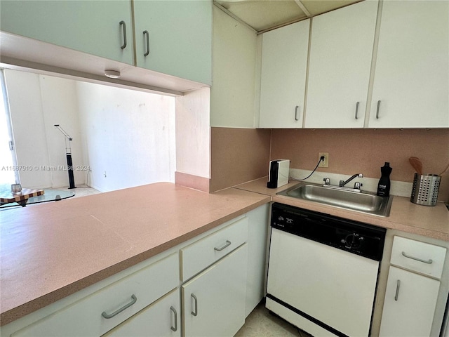 kitchen with white dishwasher, sink, and white cabinets