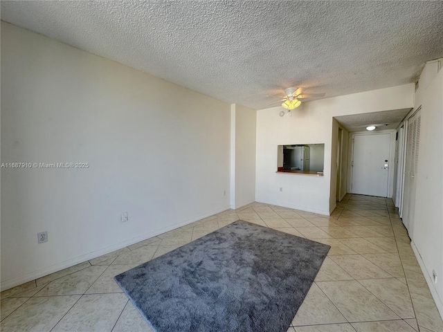 tiled living room featuring a textured ceiling and ceiling fan