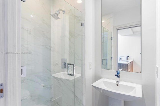 bathroom featuring an enclosed shower and sink