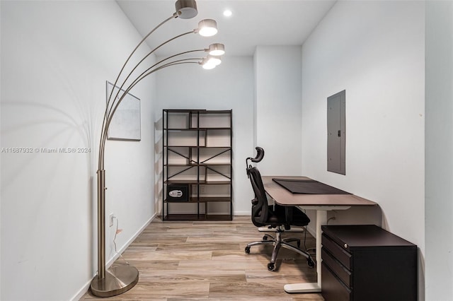 office area featuring light hardwood / wood-style flooring and electric panel