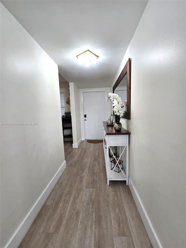 hall with hardwood / wood-style floors