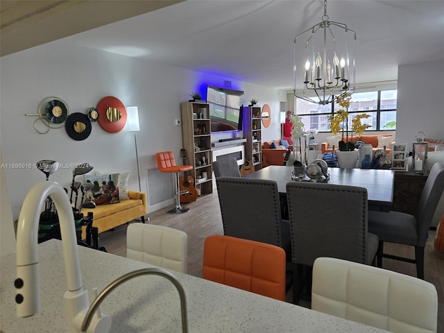 dining area featuring a notable chandelier and wood-type flooring