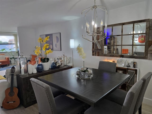 dining room with hardwood / wood-style flooring and a chandelier