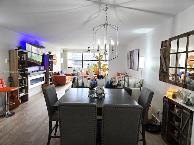 dining area with a notable chandelier and hardwood / wood-style flooring