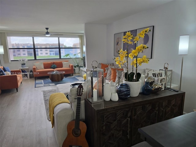 living room featuring light hardwood / wood-style floors and ceiling fan