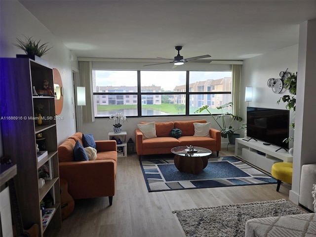 living room featuring ceiling fan and wood-type flooring