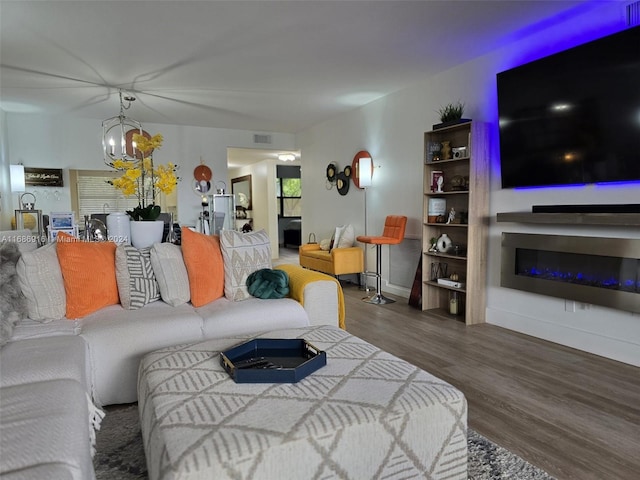 living room with a chandelier and dark hardwood / wood-style floors