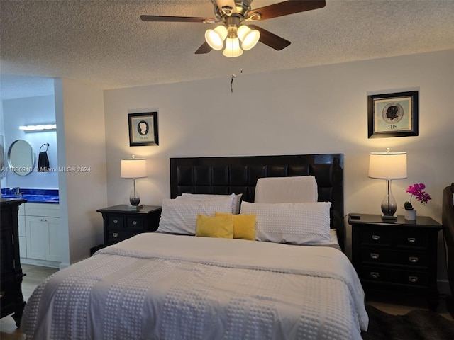 bedroom with connected bathroom, a textured ceiling, and ceiling fan