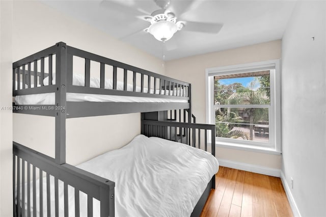 bedroom with wood-type flooring and ceiling fan