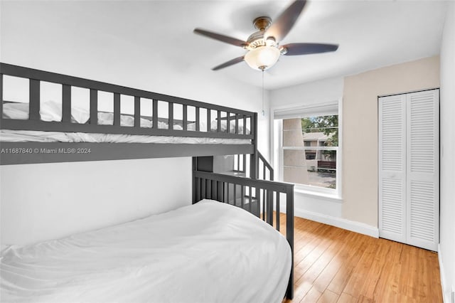 bedroom featuring hardwood / wood-style floors, a closet, and ceiling fan