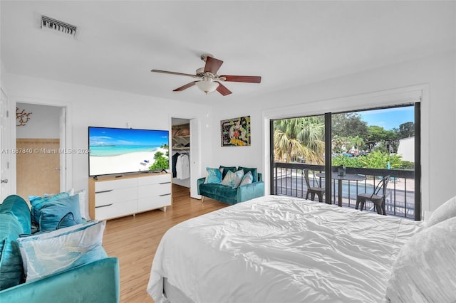 bedroom with a closet, ceiling fan, access to outside, and light wood-type flooring