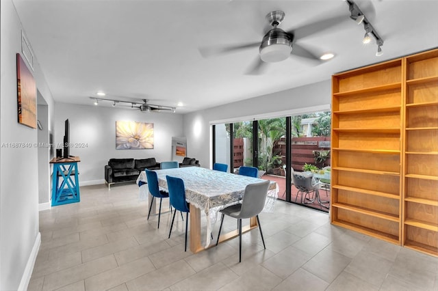 tiled dining area with ceiling fan and track lighting