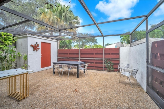 view of patio / terrace featuring glass enclosure