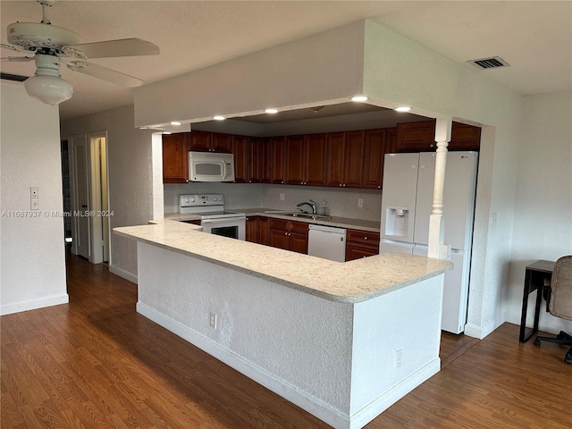 kitchen featuring white appliances, dark hardwood / wood-style floors, sink, kitchen peninsula, and ceiling fan