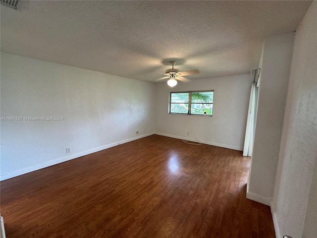 unfurnished room with a textured ceiling, dark hardwood / wood-style floors, and ceiling fan