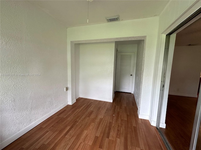 corridor with dark hardwood / wood-style floors