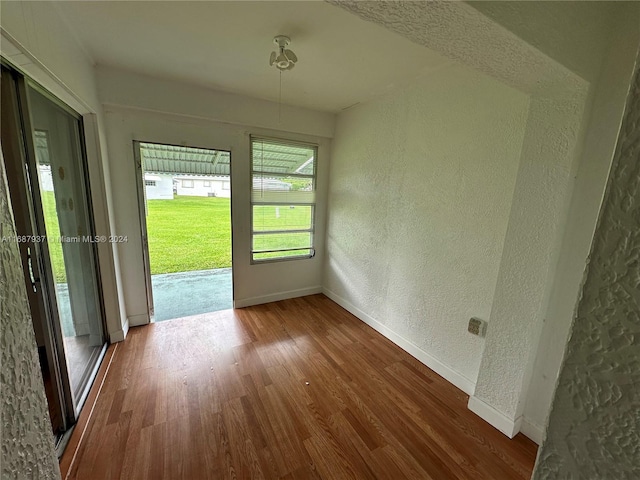 empty room with hardwood / wood-style floors