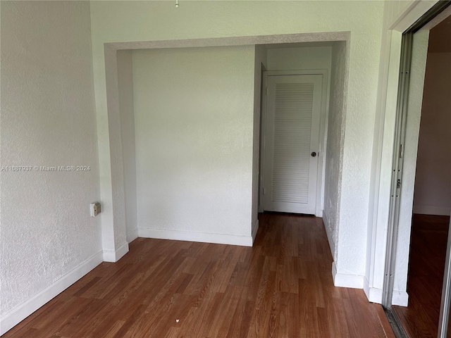 hall with dark hardwood / wood-style flooring