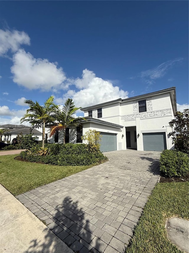 view of front of property with a front lawn and a garage