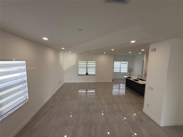 spare room featuring sink and tile patterned floors