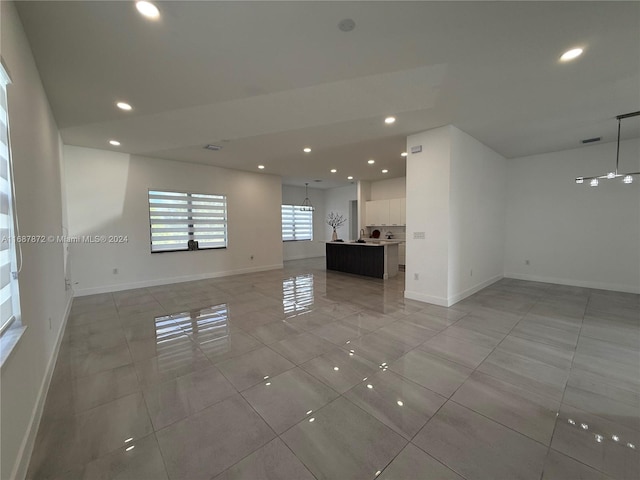 unfurnished living room with light tile patterned flooring