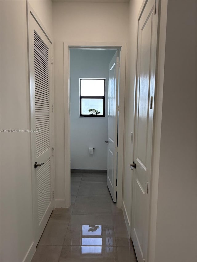 hall with dark tile patterned floors