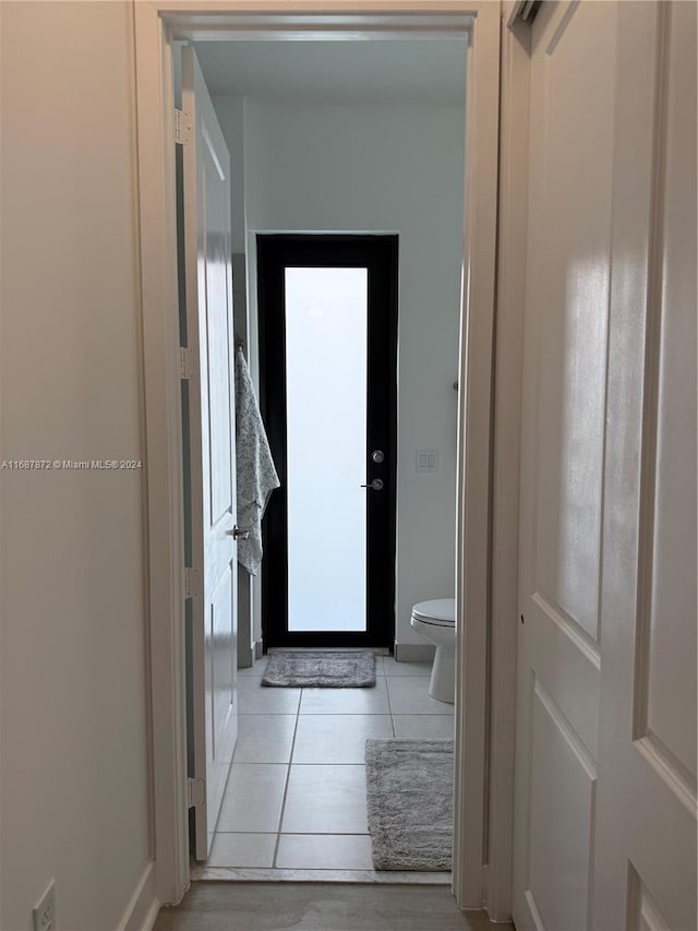 hallway featuring light tile patterned floors