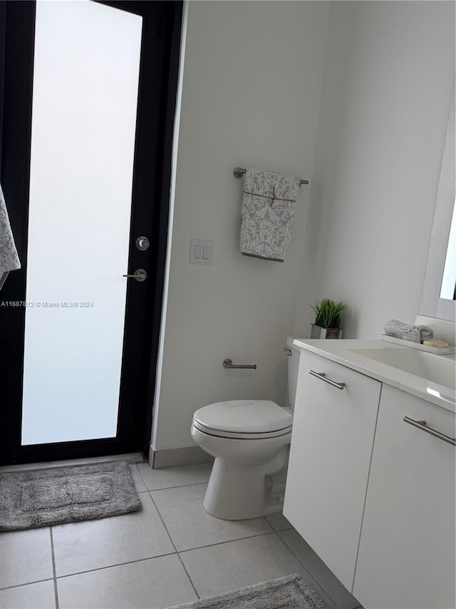 bathroom featuring vanity, toilet, and tile patterned floors