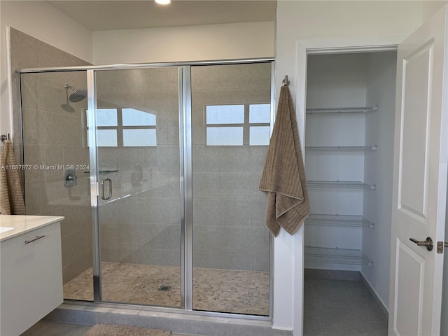 bathroom with vanity and a shower with door