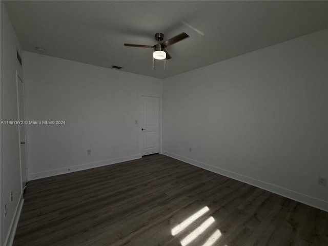 empty room featuring ceiling fan and dark hardwood / wood-style floors